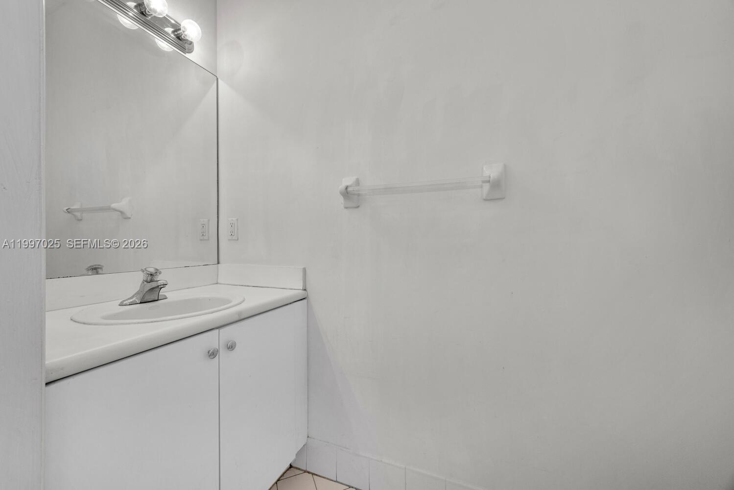 12864 Southwest 133rd Terrace Miami, FL 33186 - Photo 7 of 26 a bathroom with a sink and a mirror