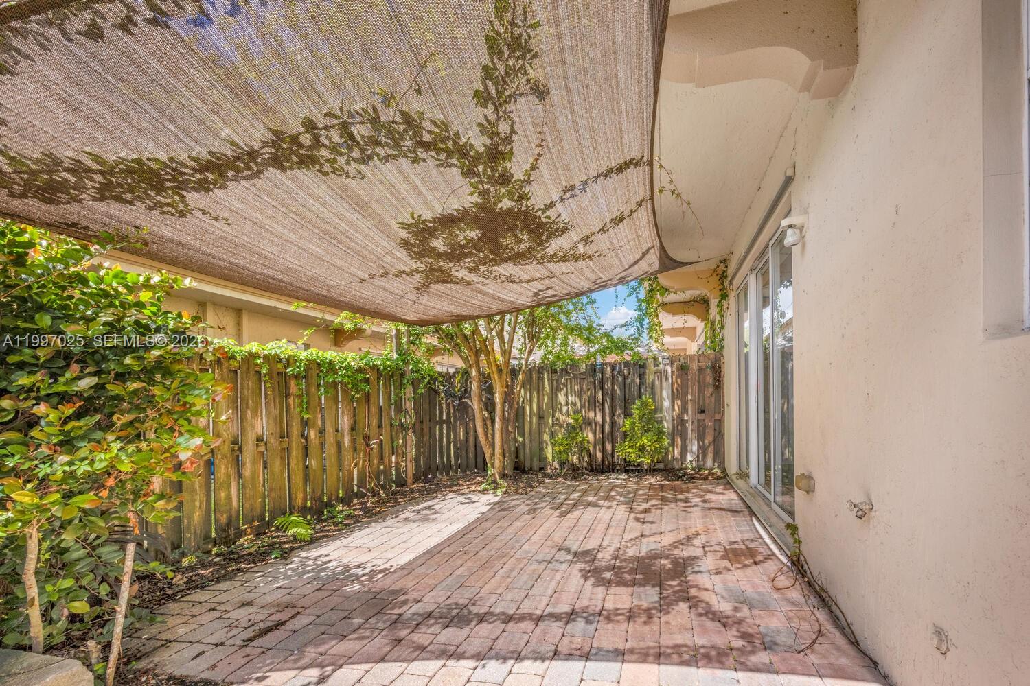 12864 Southwest 133rd Terrace Miami, FL 33186 - Photo 9 of 26 a view of a pathway with a yard