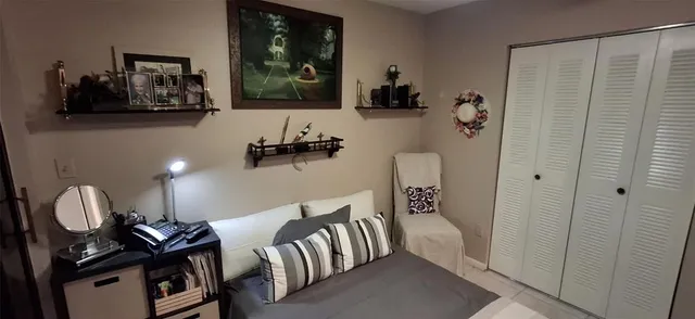 a view of a patio with table and chairs and potted plants with wooden floor and fence