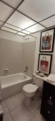 a front view of multi story residential apartment building with yard and green space