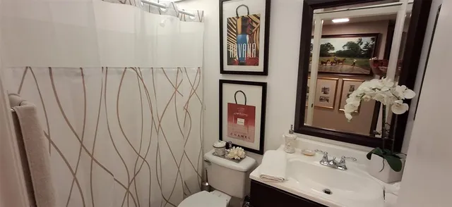 a kitchen with stainless steel appliances lots of white furniture refrigerator and cabinets