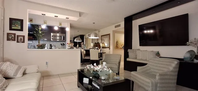 a kitchen with stainless steel appliances a refrigerator sink and microwave