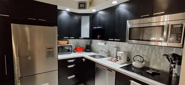 a view of walk in closet with clothes