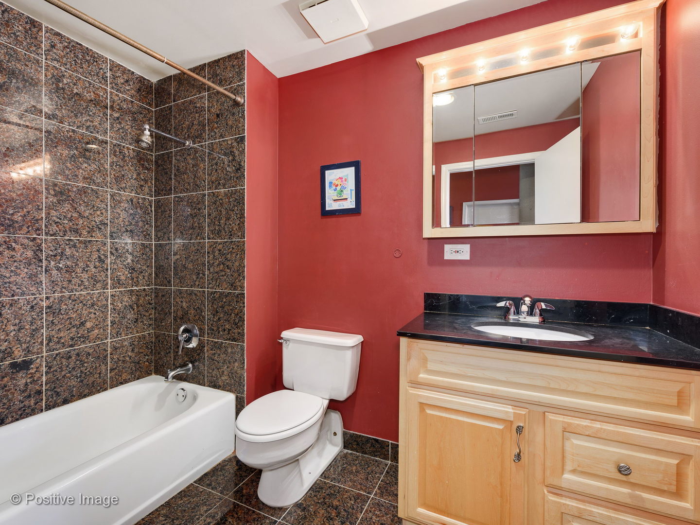 1017 West Washington Boulevard, Unit 6F Chicago, IL 60607 - Photo 12 of 20 a bathroom with a granite countertop bathtub sink vanity mirror and toilet