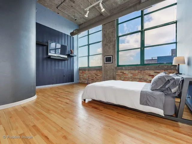 a spacious bedroom with a bed and a window