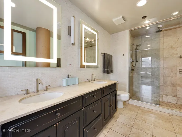 a bathroom with a granite countertop sink mirror and double