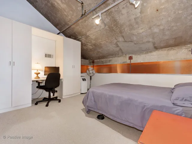 a bedroom with furniture and a rug