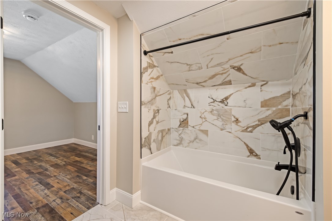 3716 Rolliston Road Cleveland, OH 44120 - Photo 24 of 37 Full bathroom with shower combination, vaulted ceiling, and wood finished floors