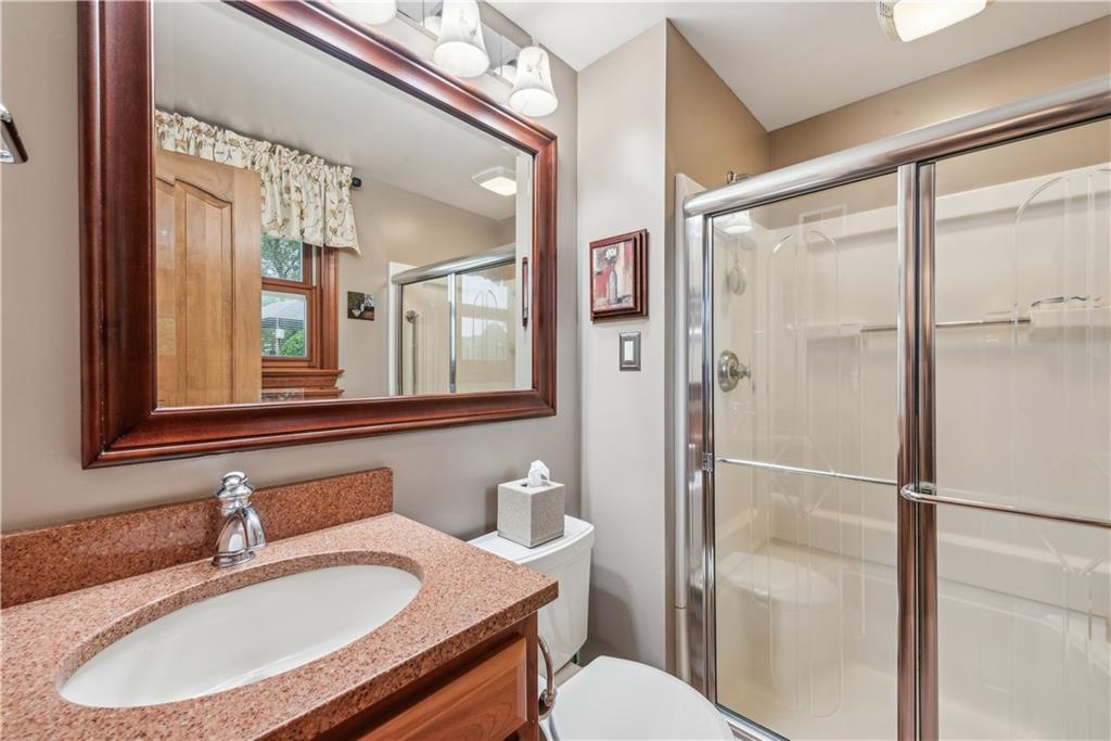 250 Victory Road Saxonburg, PA 16056 - Photo 16 of 33 a bathroom with a sink toilet a mirror and shower