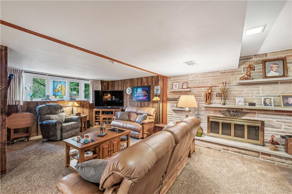 250 Victory Road Saxonburg, PA 16056 - Photo 22 of 33 a living room with furniture kitchen view and a flat screen tv