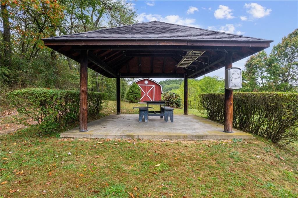 250 Victory Road Saxonburg, PA 16056 - Photo 29 of 33 a view of patio with a table and chairs under an umbrella with a small yard