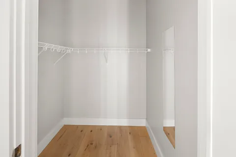 a view of a room with wooden floor
