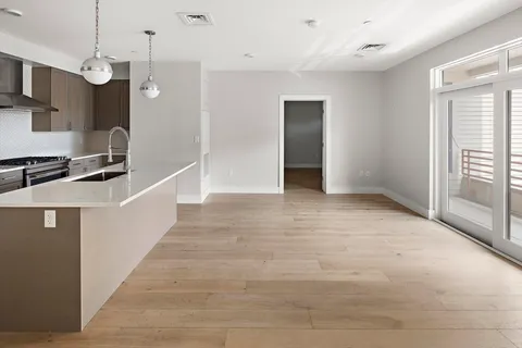 a view of a kitchen with a sink and a window