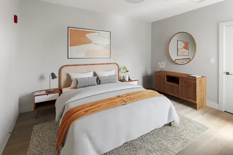 a bedroom with bed and a chair