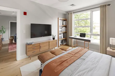 a bedroom with a bed and a flat screen tv