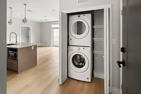 a utility room with sink dryer and washer