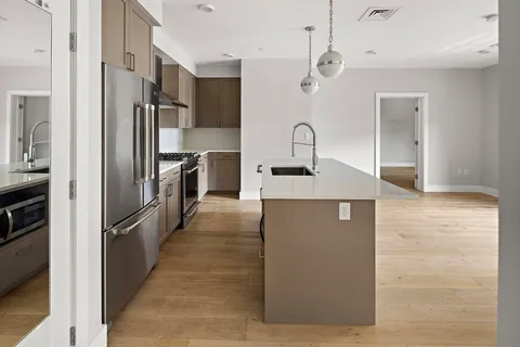 a kitchen with stainless steel appliances granite countertop a refrigerator and a sink
