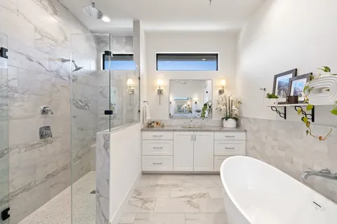 a bathroom with a granite countertop sink a toilet and shower