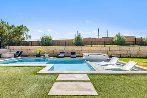 a view of a swimming pool with a lounge chairs