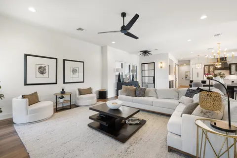 a living room with furniture rug and view of kitchen