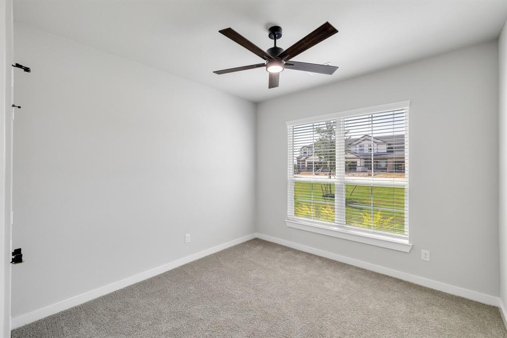 4423 Clovis Street Midlothian, TX 76065 - Photo 11 of 27 an empty room with window and ceiling fan