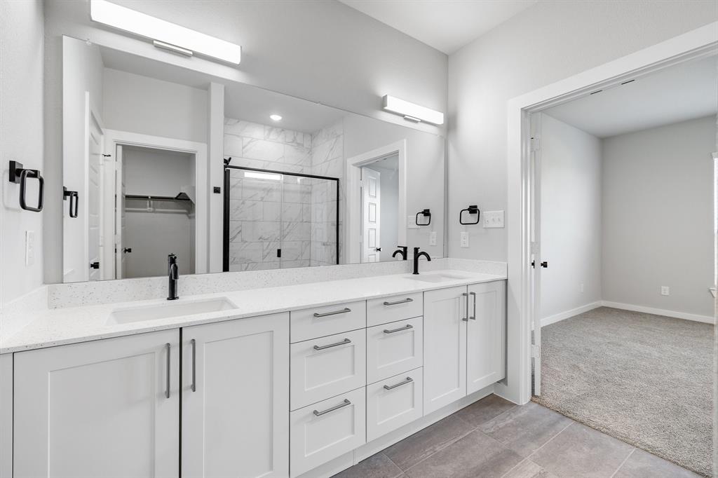 4423 Clovis Street Midlothian, TX 76065 - Photo 21 of 27 a spacious bathroom with a granite countertop sink mirror and cabinets