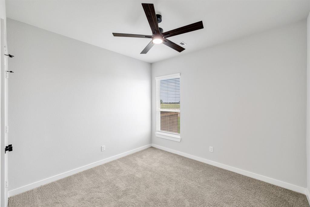 4423 Clovis Street Midlothian, TX 76065 - Photo 9 of 27 an empty room with windows and fan