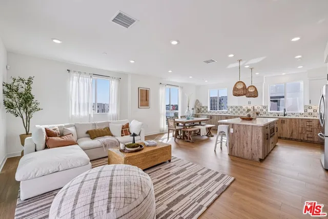 a living room with furniture kitchen and a table
