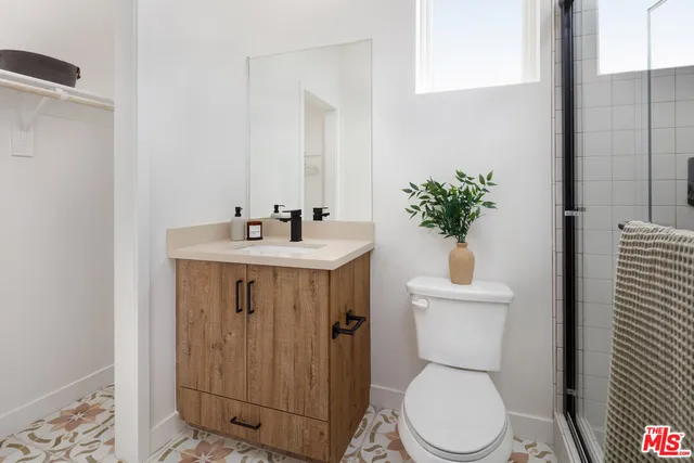 a bathroom with a toilet sink and shower