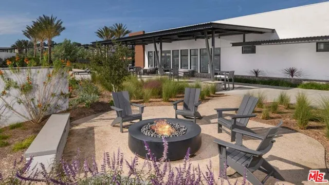 a view of a swimming pool with outdoor seating