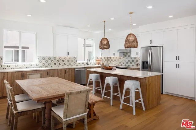 a kitchen with a table and chairs in it