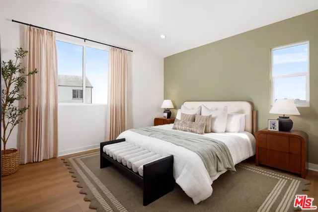 a bedroom with a bed and wooden floor