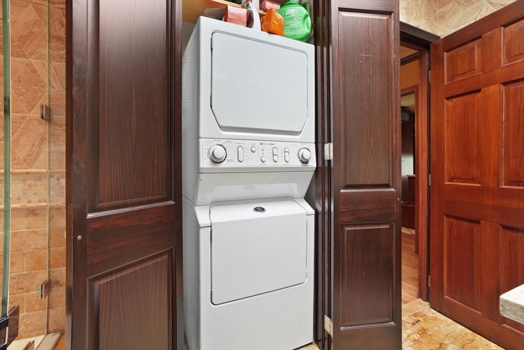131 Perkins Street, Unit 131 Boston, MA 02130 - Photo 16 of 21 storage and utility room with washer and dryer