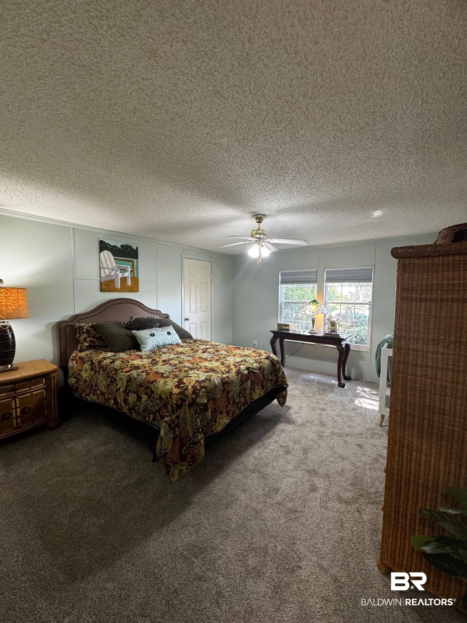 1882 Cisco Circle Lillian, AL 36549 - Photo 10 of 40 Bedroom with carpet floors, a textured ceiling, and ceiling fan