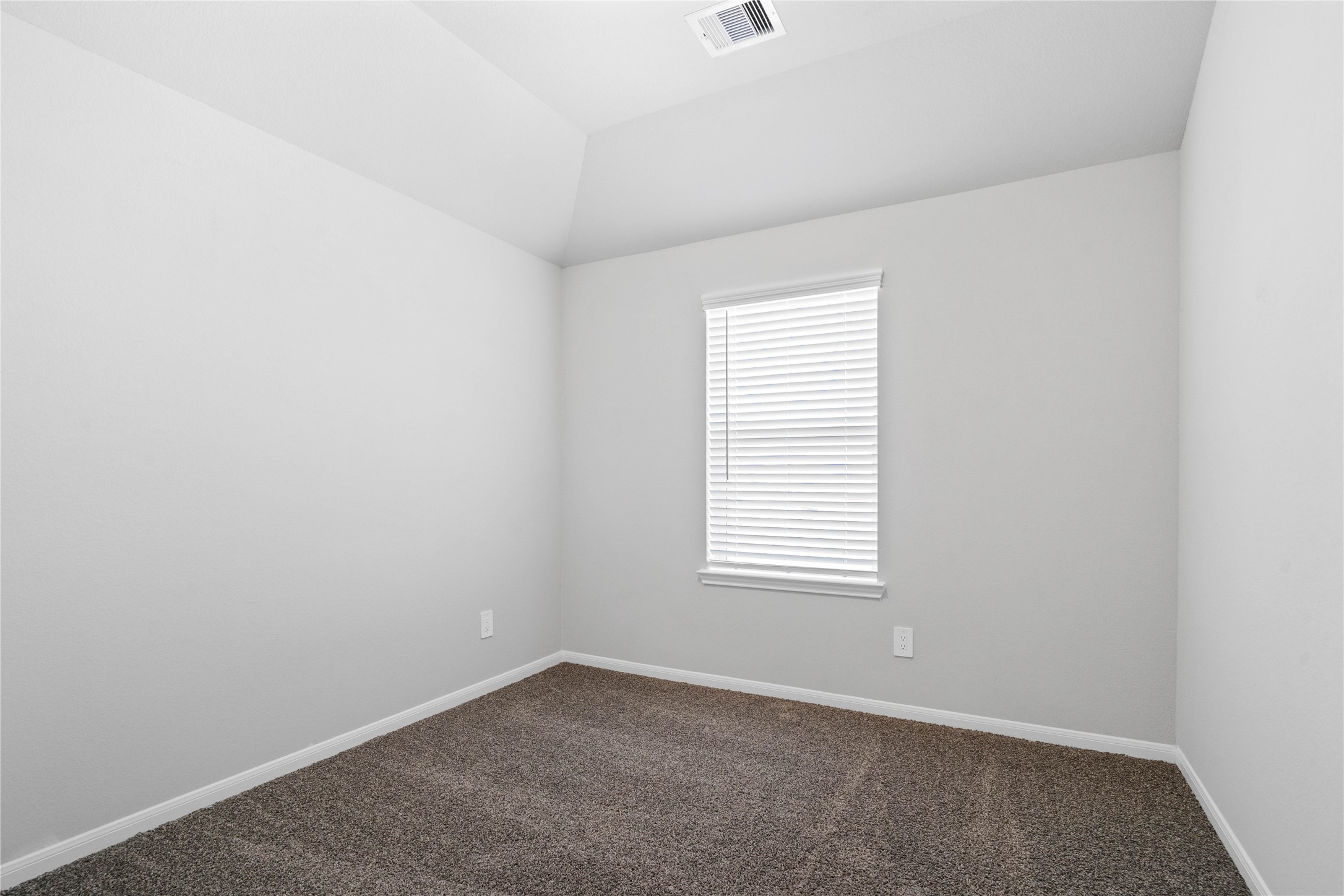 19657 Montgomery Rdg Way Montgomery, TX 77316 - Photo 37 of 49 This inviting secondary bedroom combines comfort and modern elegance, featuring plush carpeting, a neutral color palette, closet, and abundant natural light streaming through a large window.