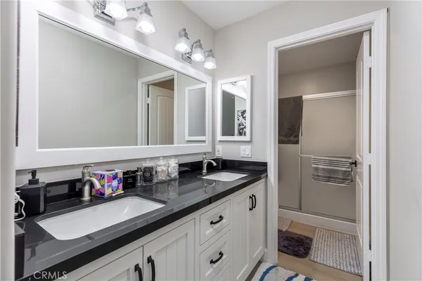 a bathroom with a sink double vanity and a mirror