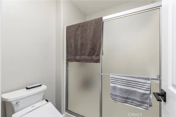 a bathroom with a shower and a toilet