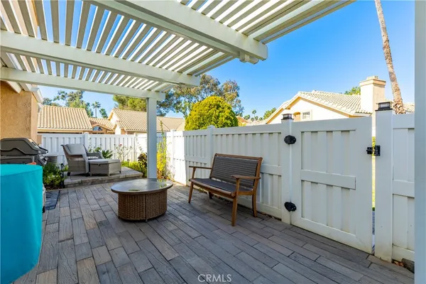 a view of a patio with table and chairs and potted plants