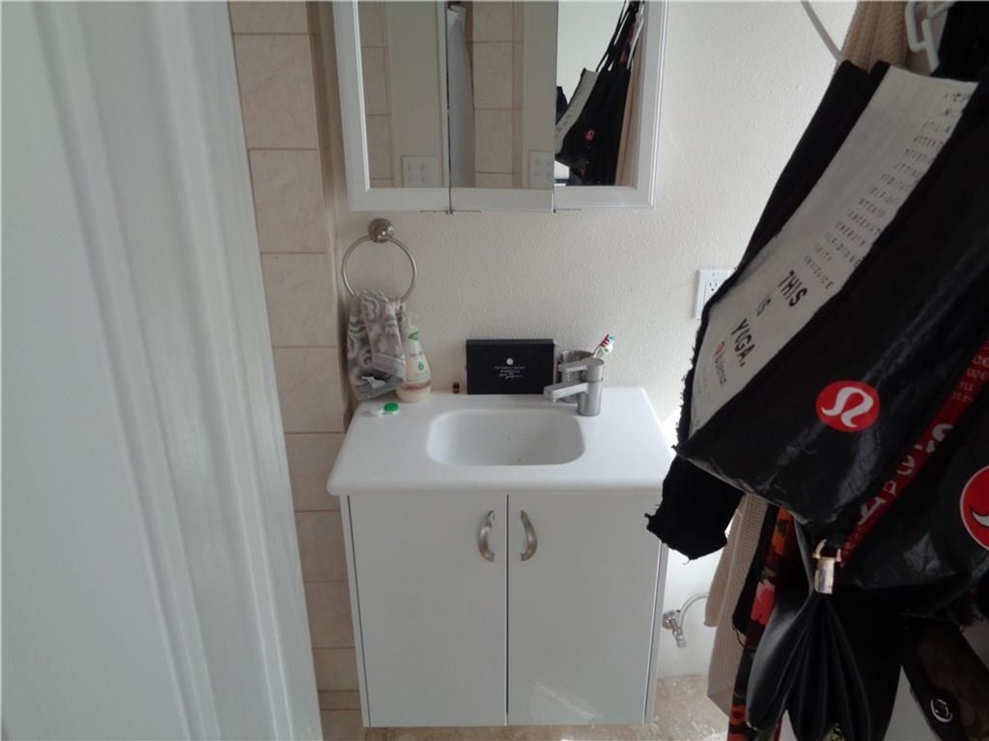 210 East 32nd Street, Unit E Austin, TX 78705 - Photo 12 of 24 a bathroom with a sink and mirror