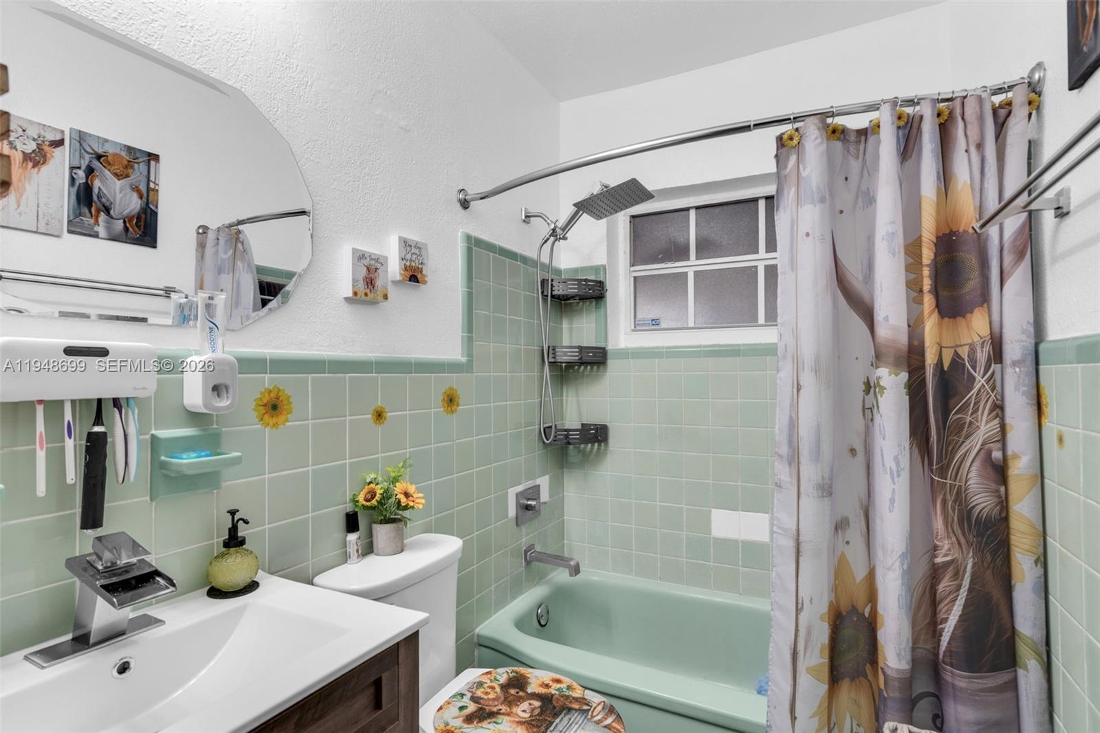 2671 Southwest 30th Avenue Miami, FL 33133 - Photo 12 of 43 a bathroom with a sink a bathtub and shower