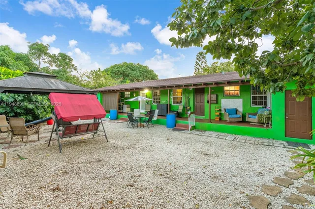 a view of an house with backyard porch and furniture