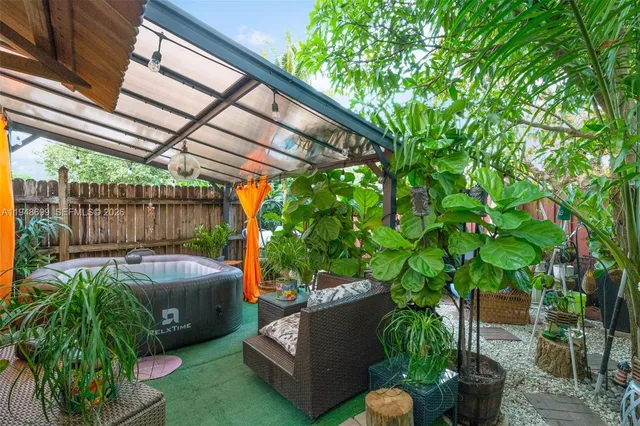 a backyard of a house with yard and outdoor seating