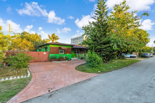 a front view of a house with a yard and pathway