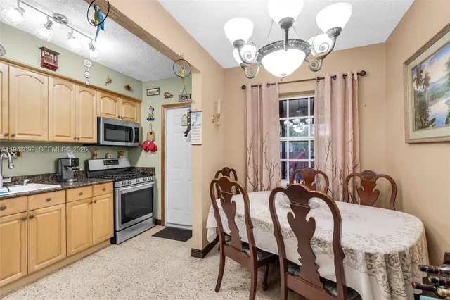a view of a dining room with furniture and chandelier