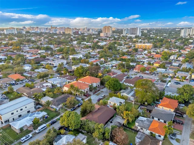 an aerial view of residential houses with city view