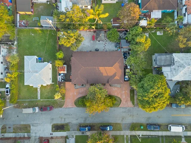 an aerial view of a house with a yard
