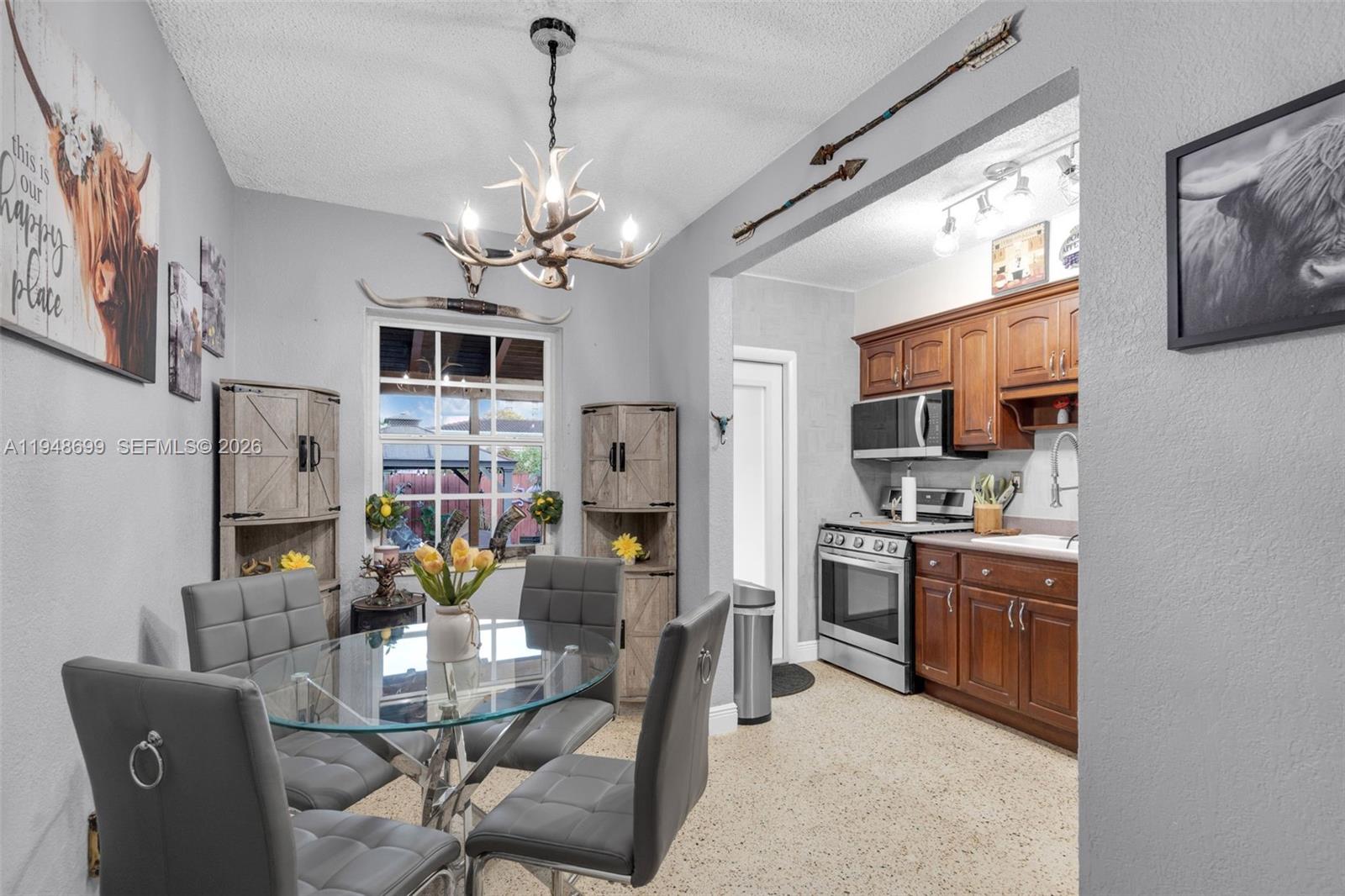 2671 Southwest 30th Avenue Miami, FL 33133 - Photo 6 of 43 a living room with stainless steel appliances furniture a fireplace and a flat screen tv