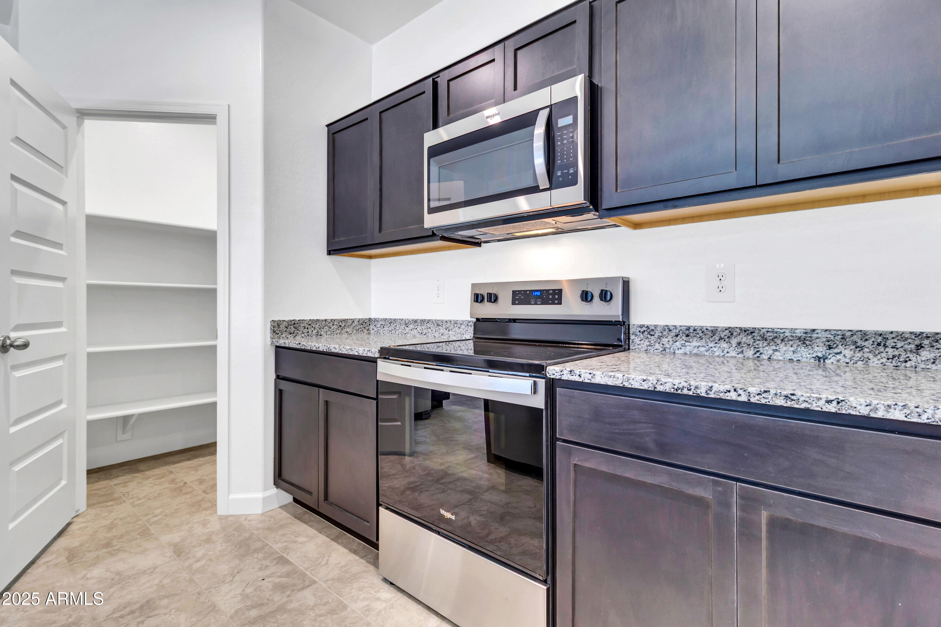 2108 West Sheridan Avenue Apache Junction, AZ 85120 - Photo 12 of 49 a kitchen with stainless steel appliances granite countertop a sink and a microwave