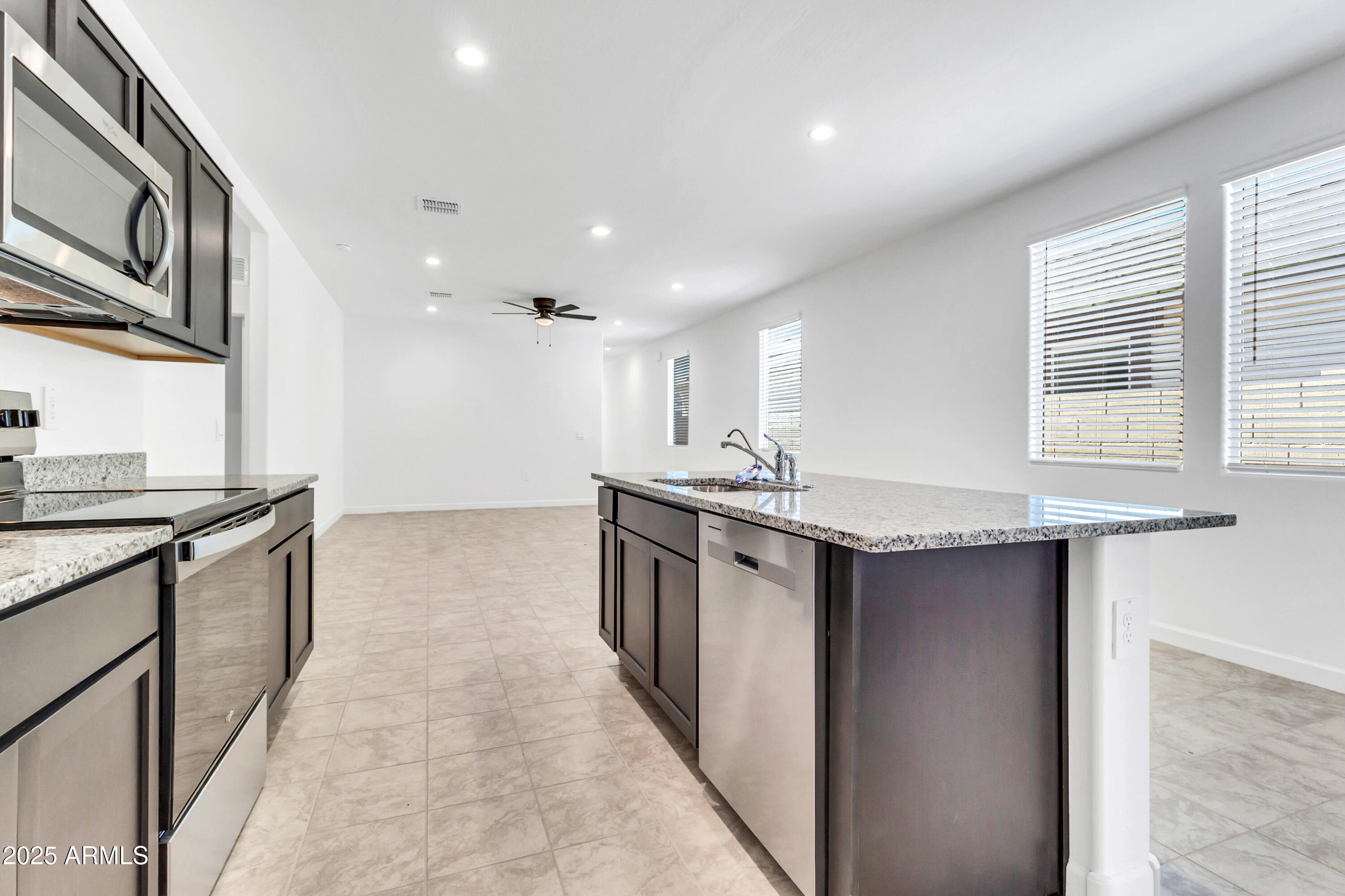 2108 West Sheridan Avenue Apache Junction, AZ 85120 - Photo 13 of 49 a kitchen with stainless steel appliances granite countertop a sink and a stove
