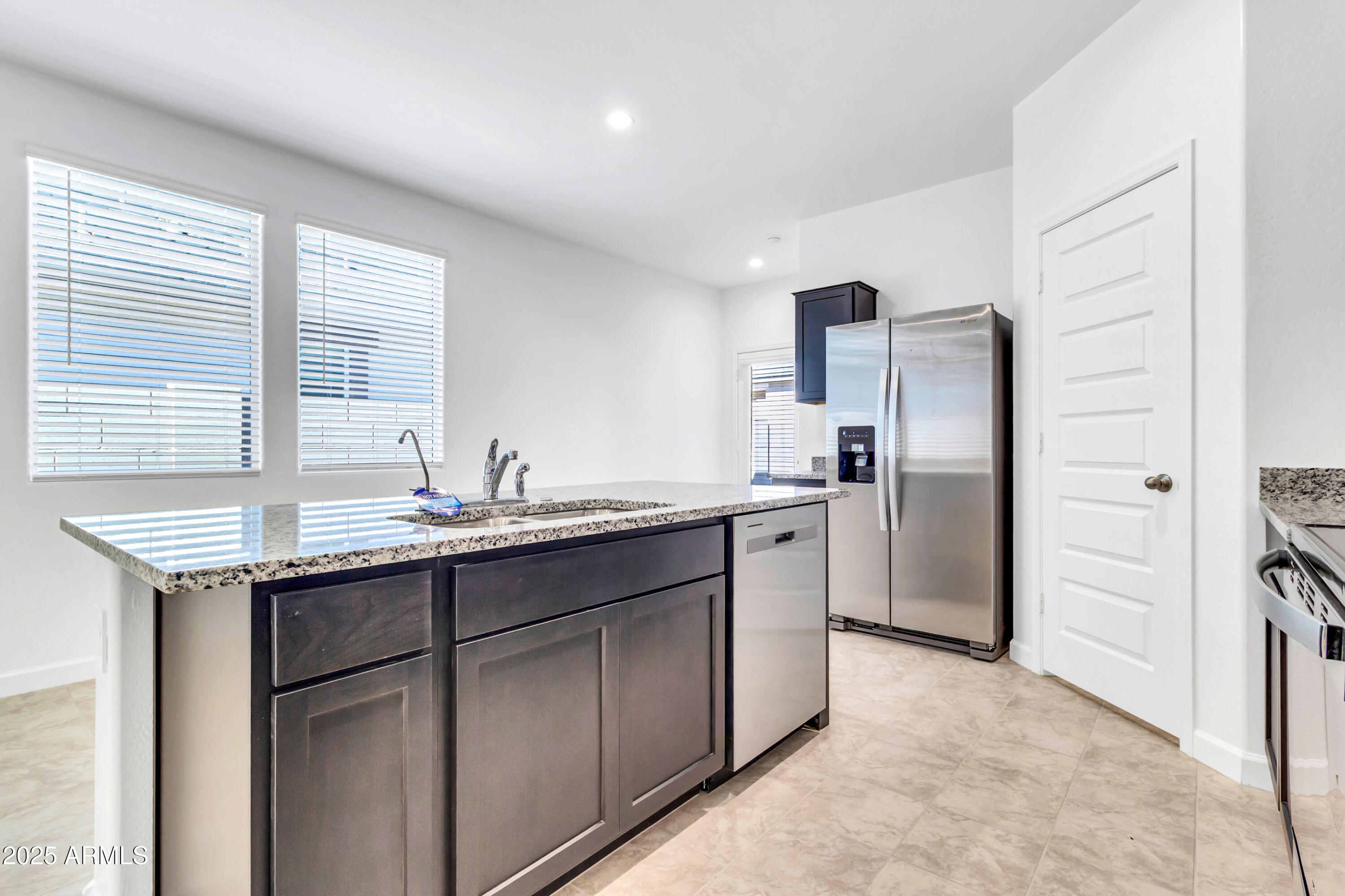2108 West Sheridan Avenue Apache Junction, AZ 85120 - Photo 15 of 49 a kitchen with stainless steel appliances granite countertop a refrigerator and a sink